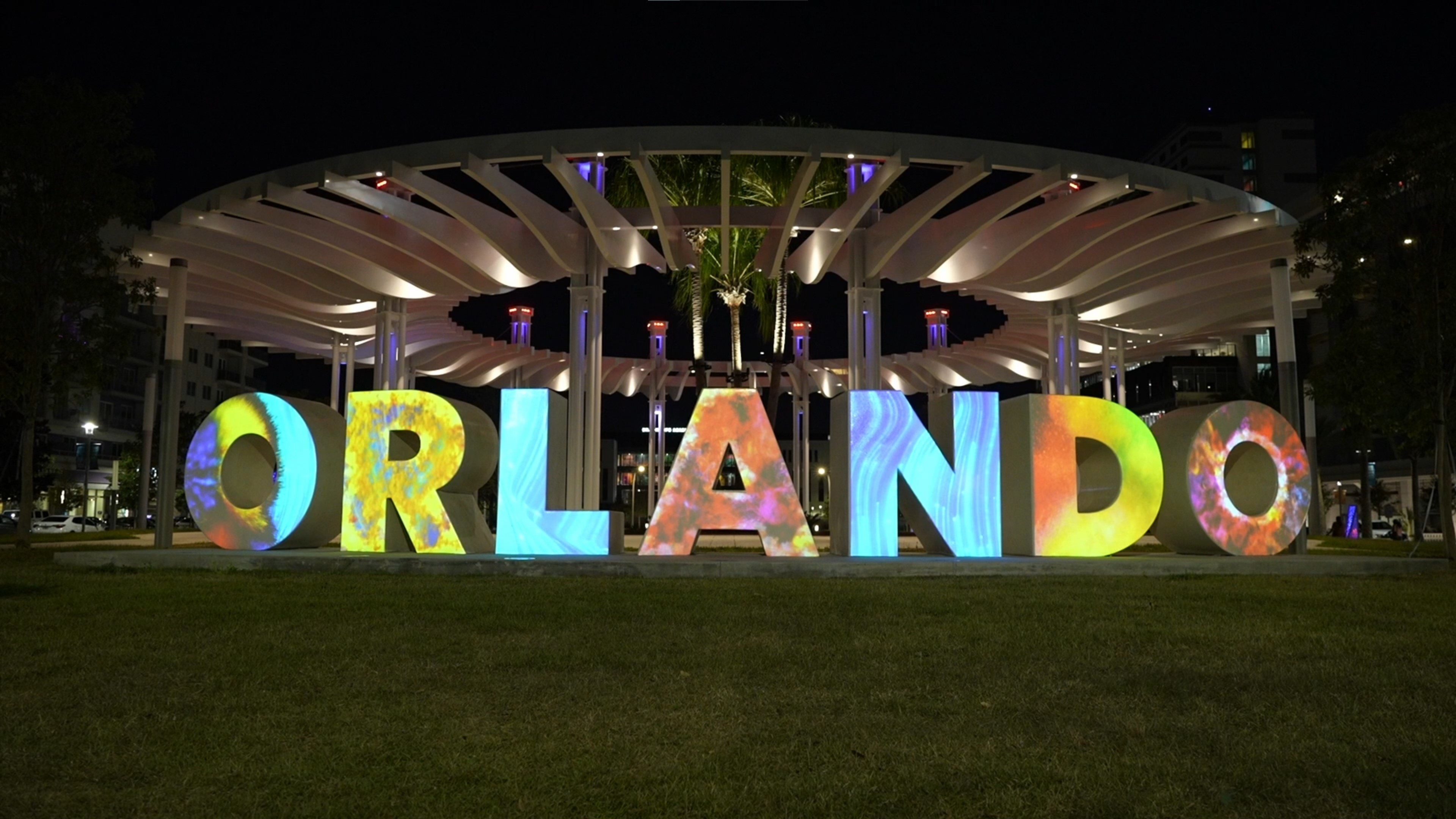Orlando sign at night with colorful projection
